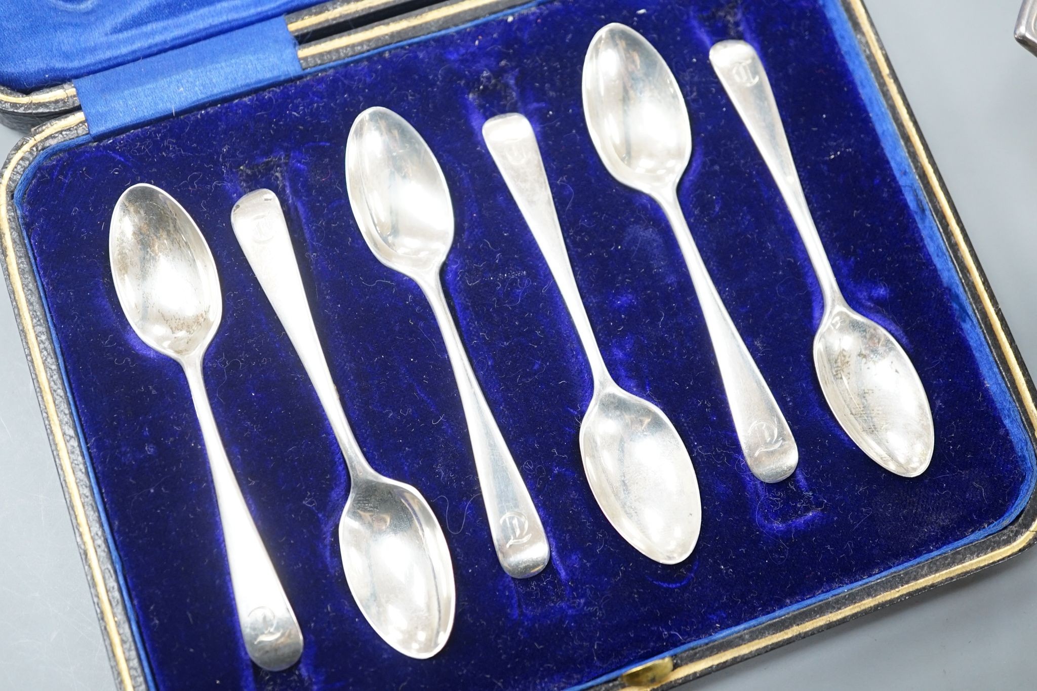 A set of six silver teaspoons, a silver two handled small butter dish, with glass liner and silver mounted cut glass toilet jar.